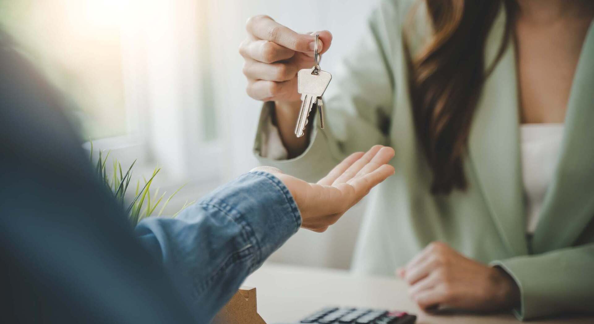 A woman handing over a set of keys