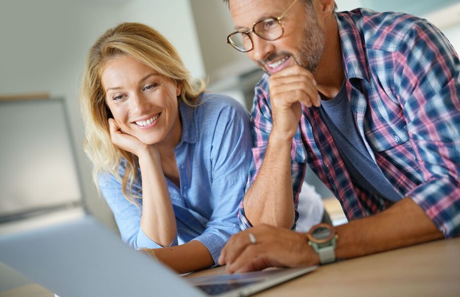 Two people viewing a laptop