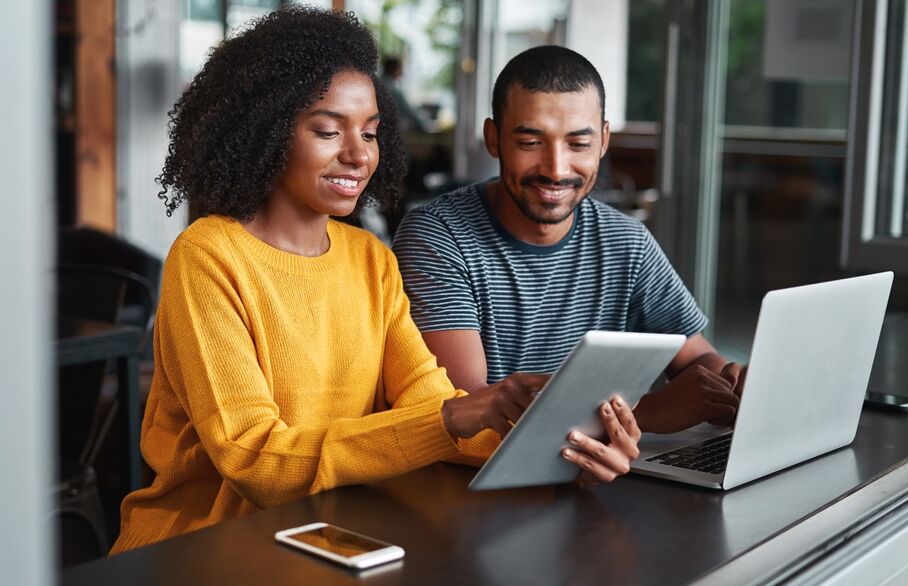 Two people looking at a laptop