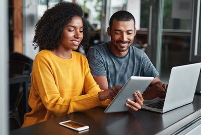 Two people looking at a laptop