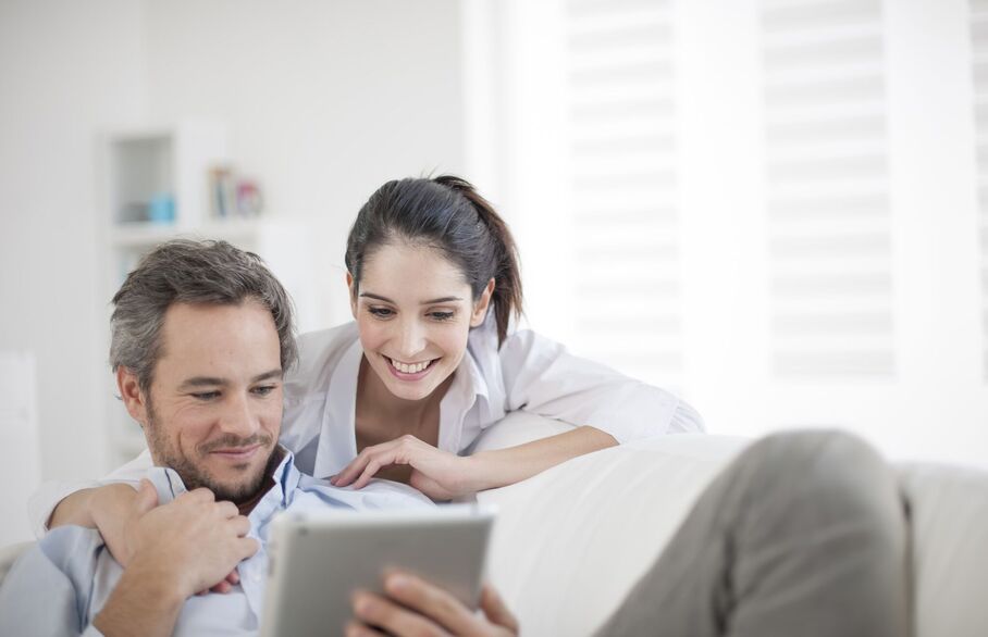 Two people looking at a tablet screen