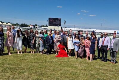 A group of people standing near a race track