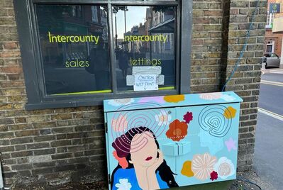 Painting of a woman on the side of the Intercounty building