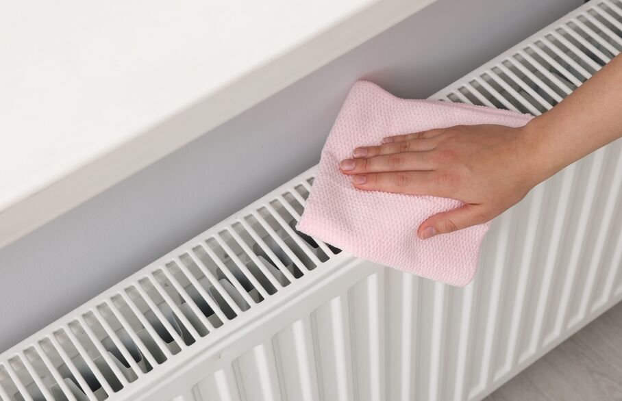 A person's hands on a radiator