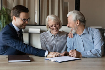 An older couple having a meeting with an estate agent