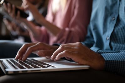 Someone typing on a keyboard