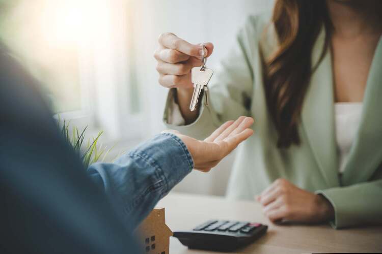 A person handing over a set of keys