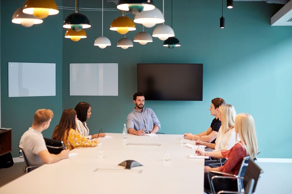 Group of graduates working in an office