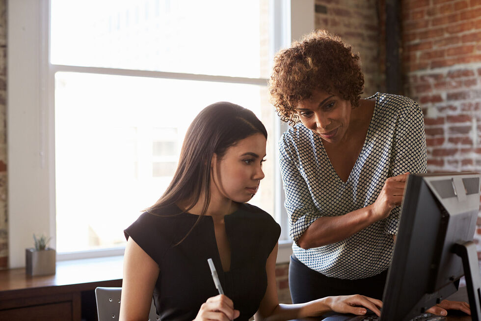Two business women working together