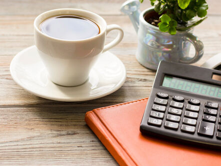 Cup of coffee and calculator
