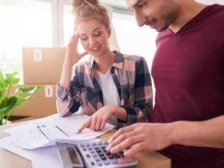 Couple examining expenses after moving into new house
