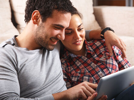 Smiling couple looking at a tablet