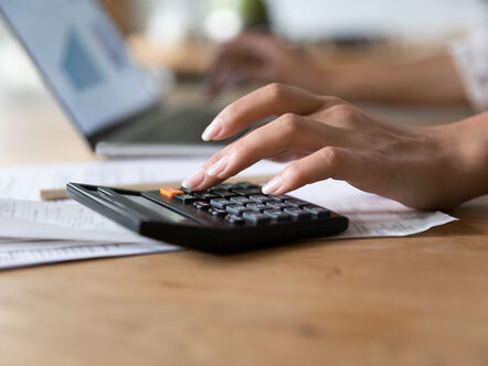 close up of a woman doing sums on a calculator